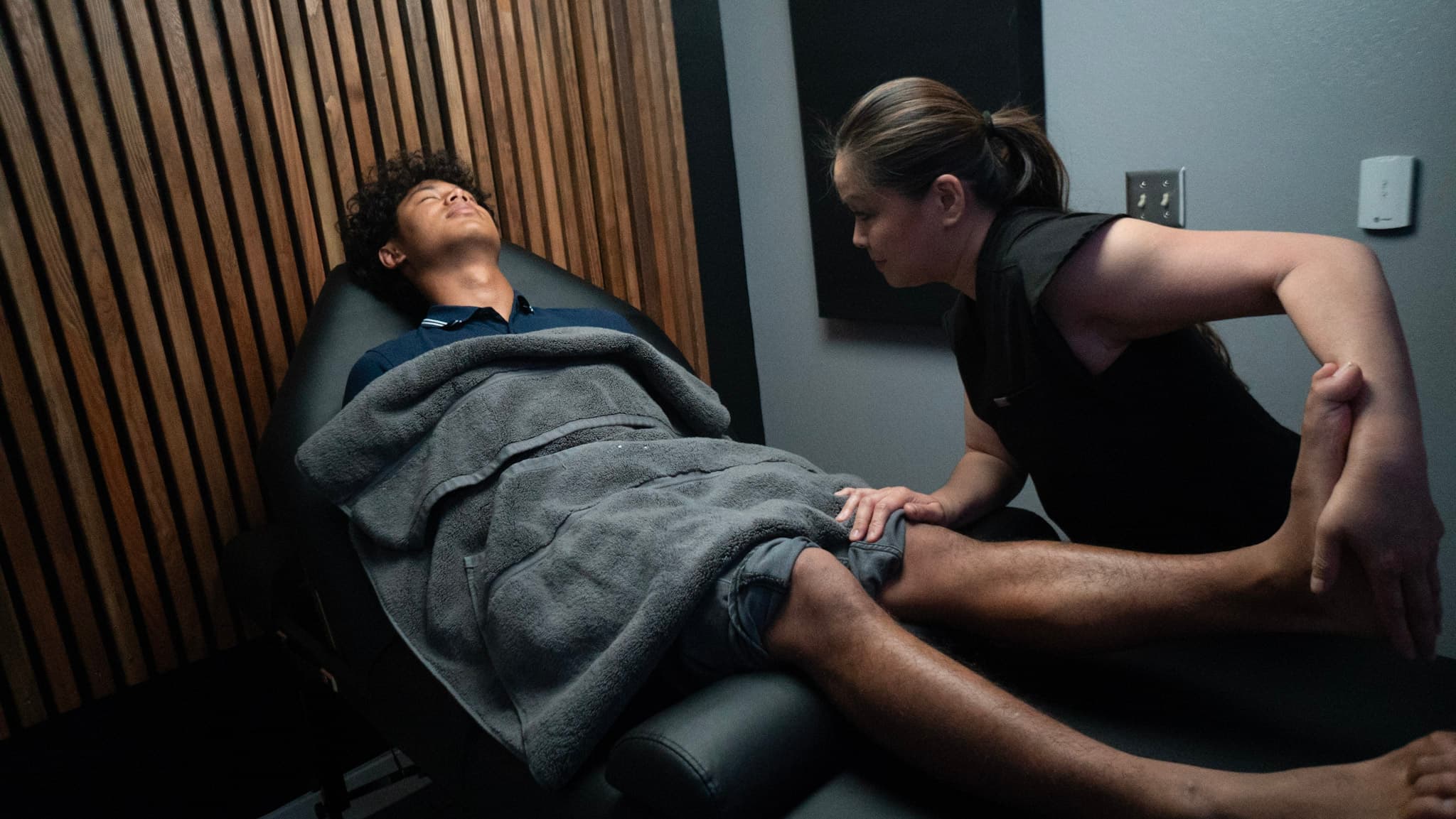 Occupational therapy session — guided range-of-motion work on the leg