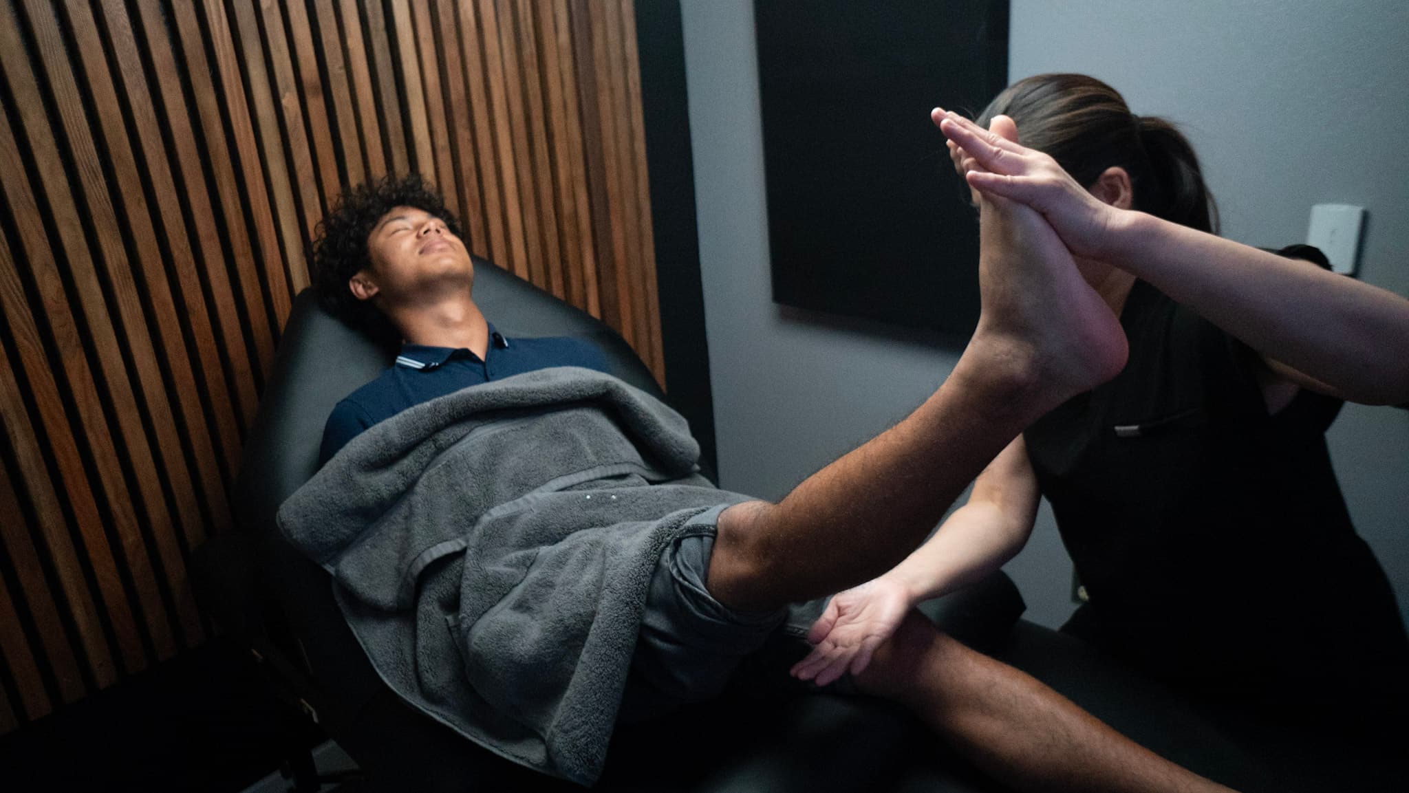 Guided lower-body range-of-motion stretch during occupational therapy